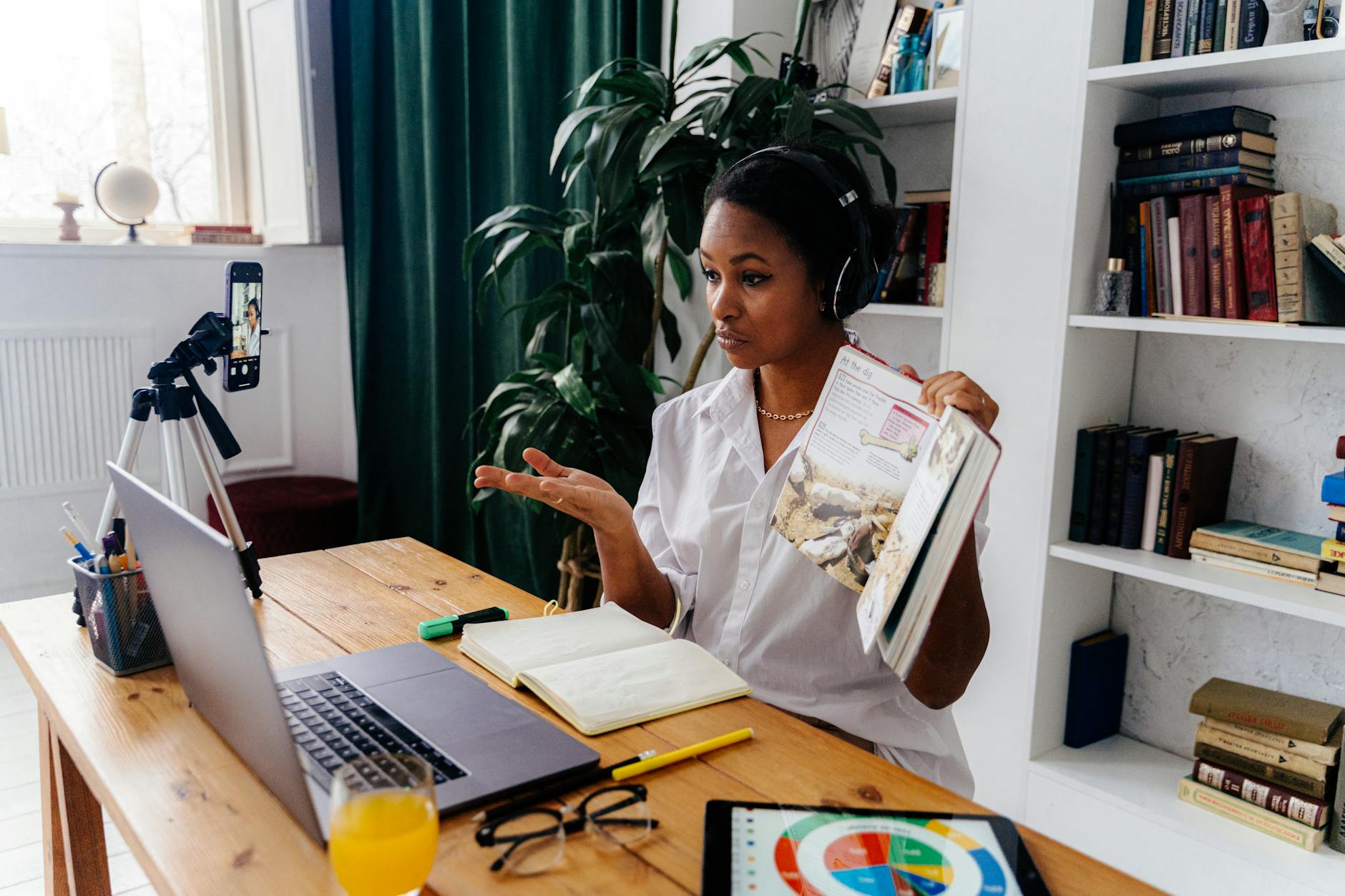 woman sitting in front of laptop teaching online